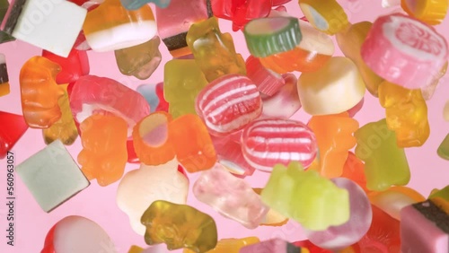 Super Slow Motion Shot of Sweet Colorful Candies Flying and Rotating Towards Camera at 1000fps. photo