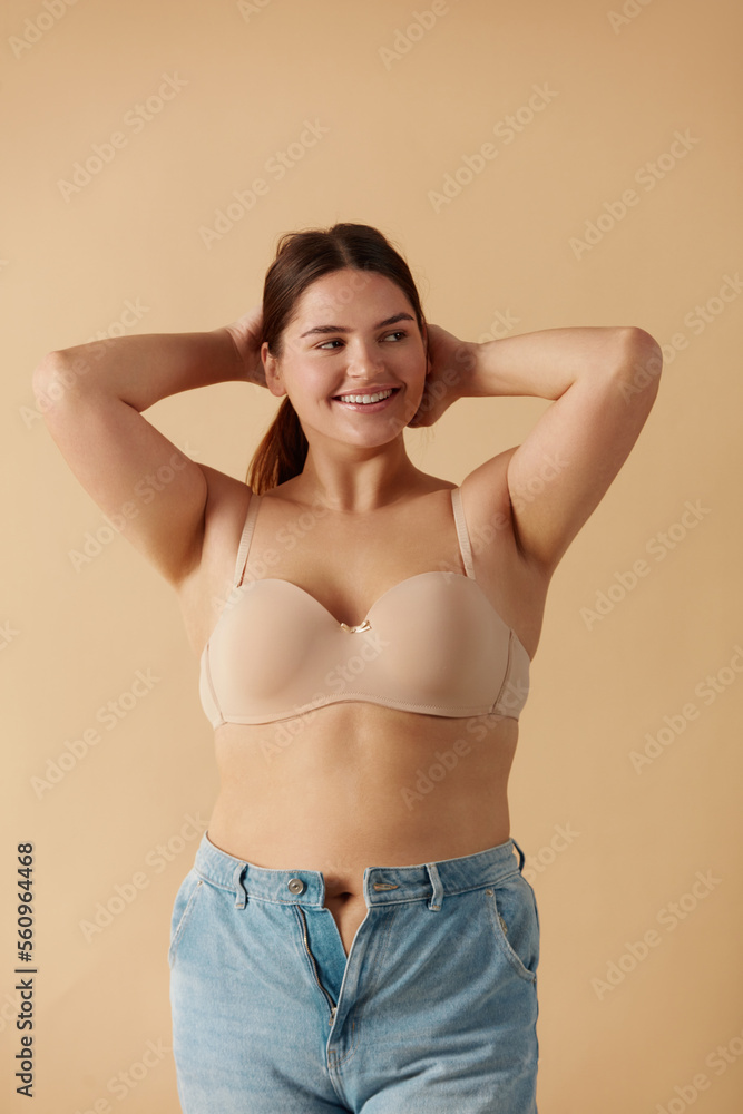 Happy young woman wearing bra and jeans, Stock Photo, Picture And