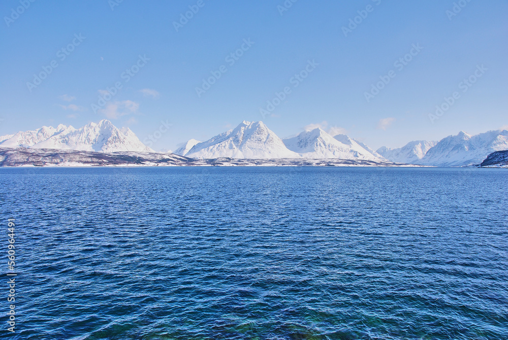 winter landscape with snow covered mountains o a fjord
