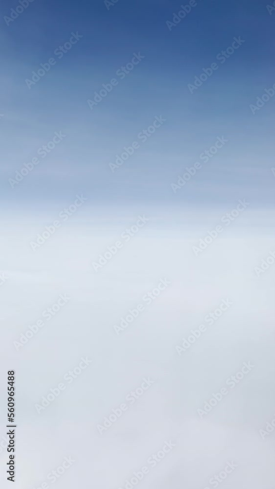 Aerial shot of white cloudscape seen from the passenger airplane. Travel and flying concept. Vertical footage. Aerial shot of white cloudscape seen from the passenger airplane. Travel and flying concept. Vertical footage.