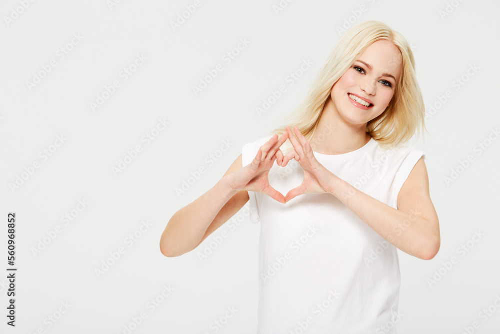 Love, heart hands and portrait of woman with smile, kindness on white background. Motivation, support and loving heart sign finger gesture, happy woman model in studio with mockup product placement. Love, heart hands and portrait of woman with smile, kindness on white background. Motivation, support and loving heart sign finger gesture, happy woman model in studio with mockup product placement.