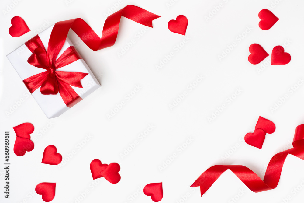 Gift box with red ribbon and hearts on white background Gift box with red ribbon and hearts on white background