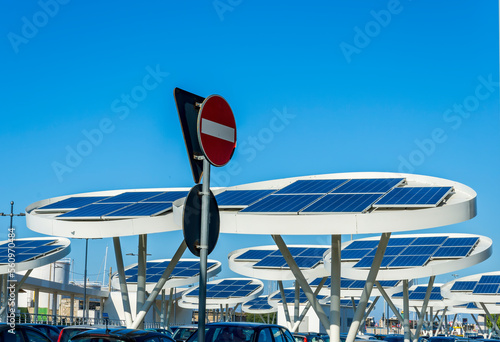 solar power plant with big antennas on a parking for charging electrocars, problems of car energy of future photo