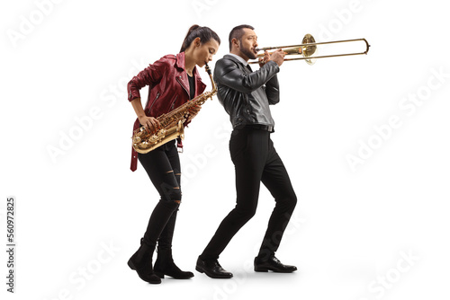 Murais de parede Full length shot of a young woman playing a sax and man playing a trombone