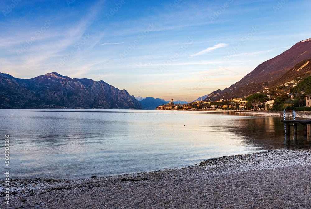 Lake Garda (Lago di Garda) and the Malcesine village at sunset. Verona province, Italy, Veneto, southern Europe. On background the coast of the Lombardy and Trentino-Alto Adige.