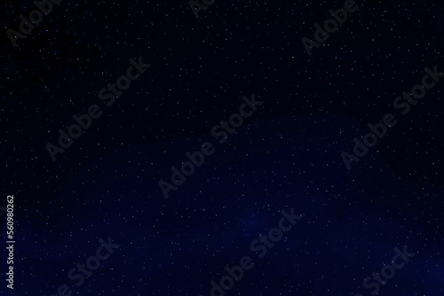 Dark blue galaxy space background. Starry night sky. Glowing stars in space.