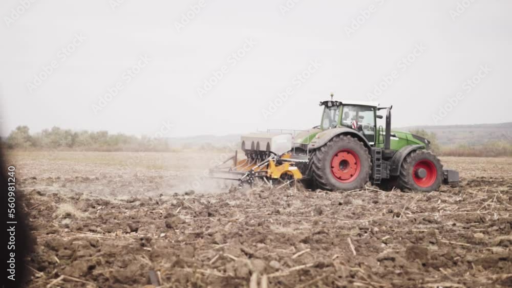 Tractor working in the field. Autumn tillage. Deep ripping with powerful tractor Tractor working in the field. Autumn tillage. Deep ripping with powerful tractor