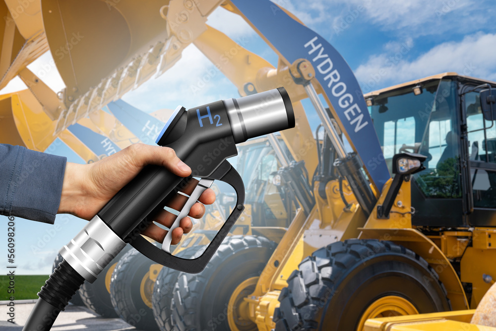 Hand with hydrogen fueling nozzle on a background of fuel cell