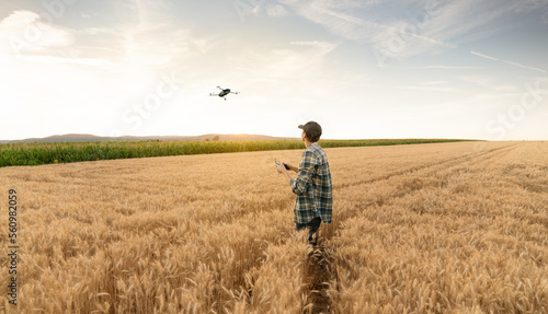 Farmer controls drone. Smart farming and precision agriculture 
