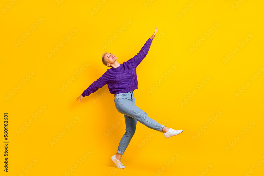 Full body photo of pretty peaceful lady dancing partying raise hands isolated on yellow color background