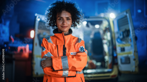Portrait of Beautiful, Multiethnic, Female Paramedic Specialist on Late Night Shift. Heroic Empowering Woman Smiling and posing for Camera, Reporting for Duty to Save Lives and Treat Emergencies photo