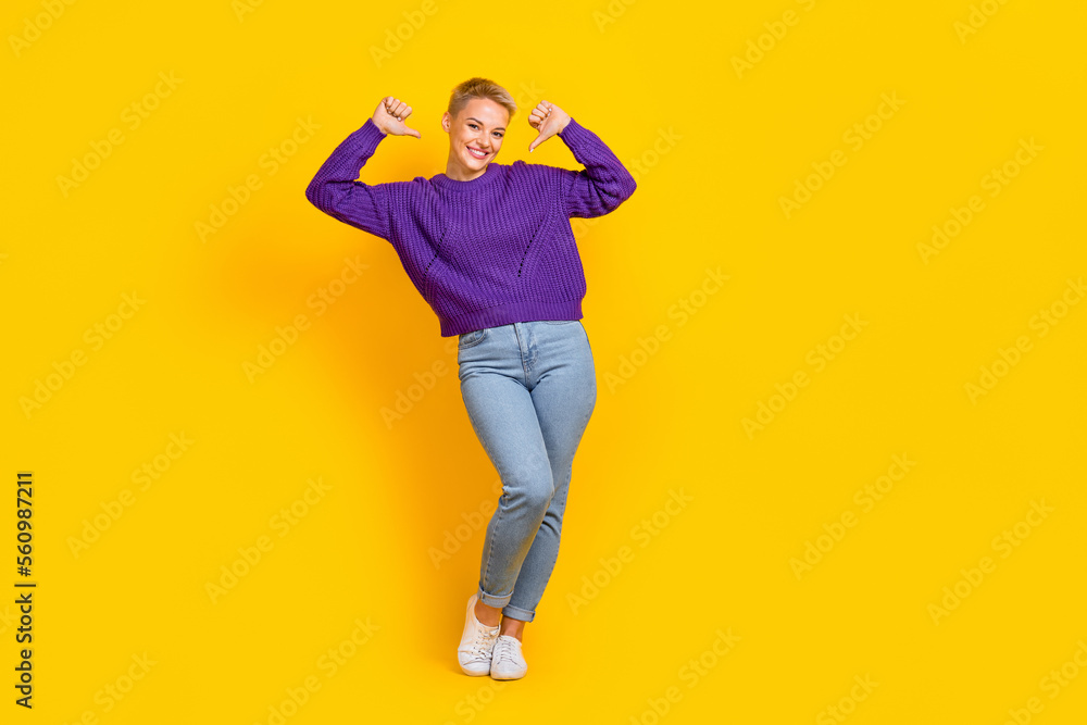 Full length photo of satisfied glad person toothy smile indicate thumb fingers self herself isolated on yellow color background Full length photo of satisfied glad person toothy smile indicate thumb fingers self herself isolated on yellow color background