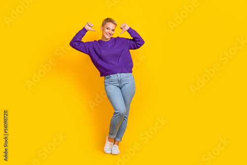 Full length photo of satisfied glad person toothy smile indicate thumb fingers self herself isolated on yellow color background