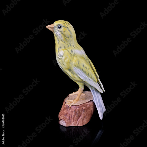antique figurine of a titmouse on a black isolated background. sparrow toy. vintage porcelain bird figurine