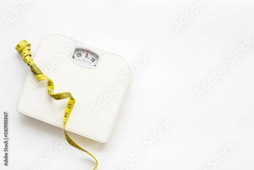Weight scale and tape measure top view. Weight control concept
