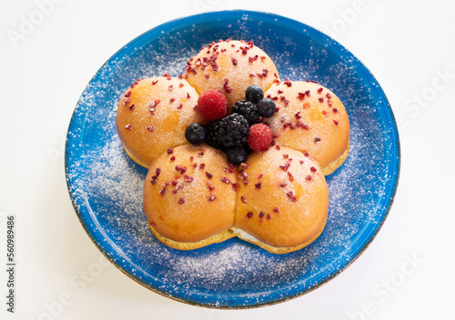Wallpaper Mural Home cooking concept. Fresh organic homemade sweet soft milk bread filled with cream and decorated with berries, on blue dish Torontodigital.ca