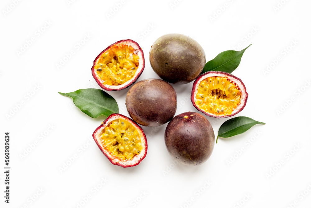 Whole and half of fresh passion fruit with leaf, top view Whole and half of fresh passion fruit with leaf, top view