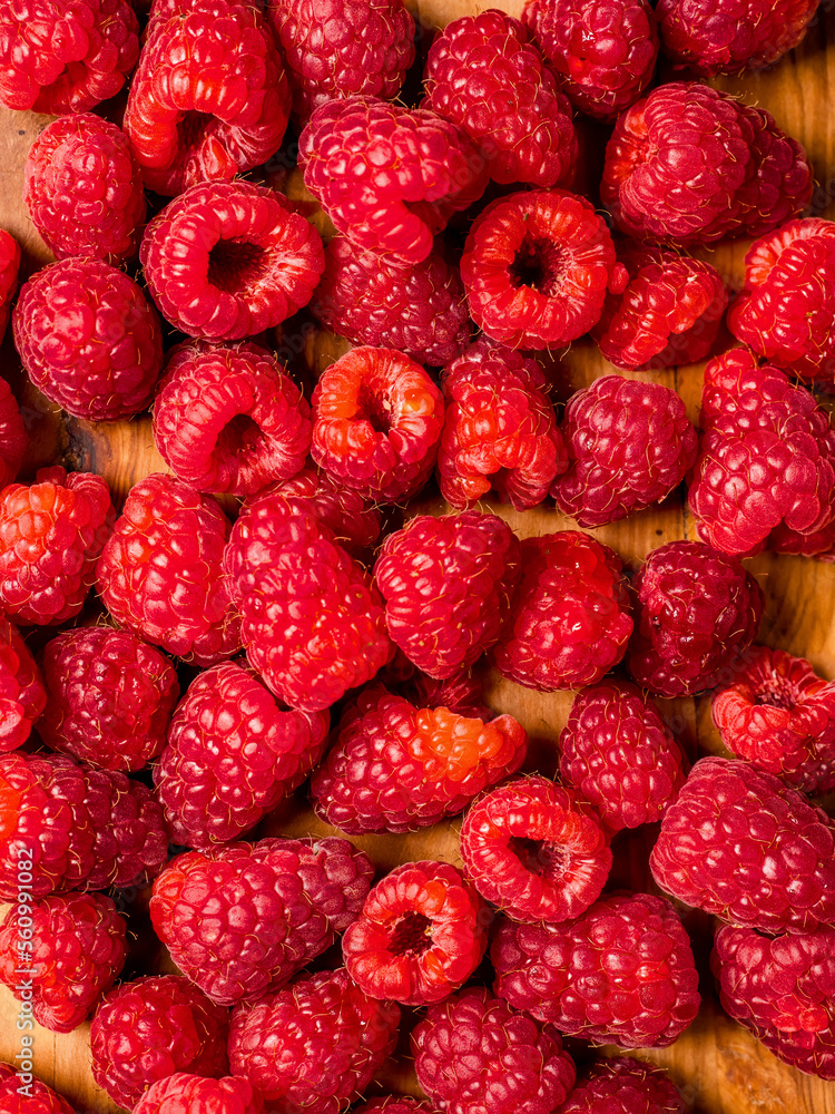 Fresh raw raspberry on wooden board and white isolated background. Fruit product for sale. Fresh raw raspberry on wooden board and white isolated background. Fruit product for sale.