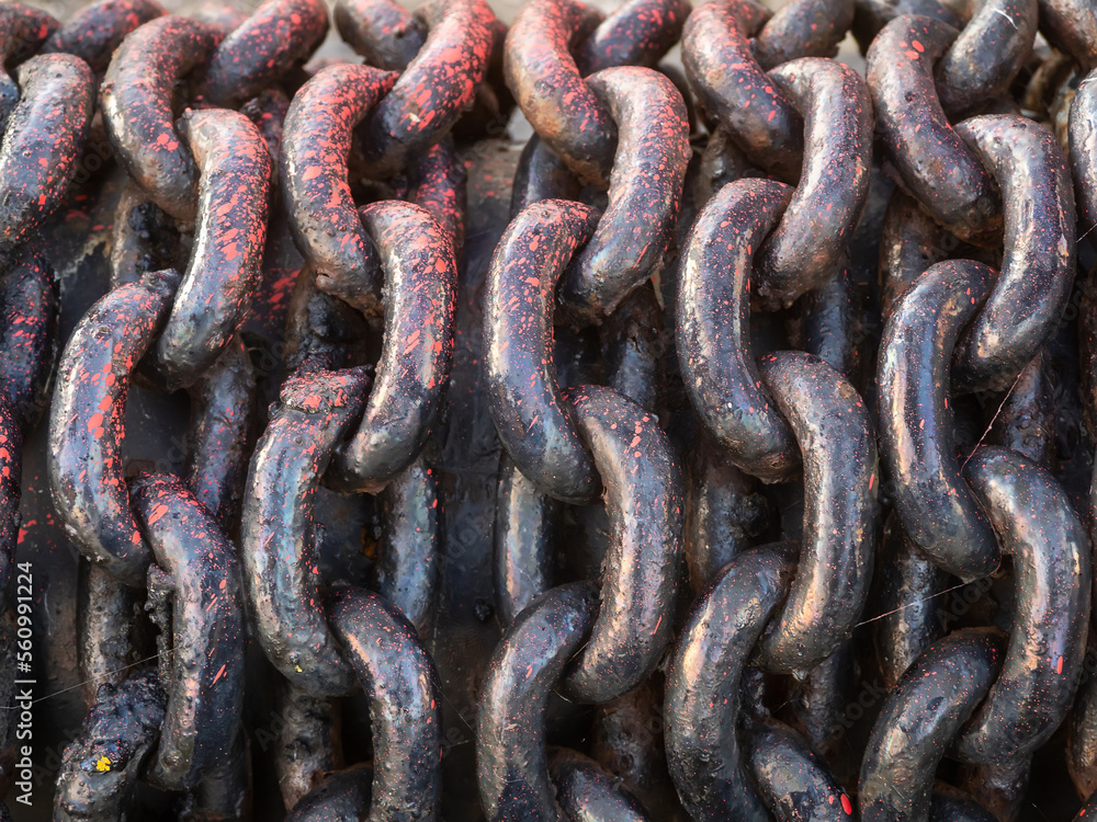 Solid metal chain on a anchor roll of a ship. Power and security concept. Solid metal chain on a anchor roll of a ship. Power and security concept.