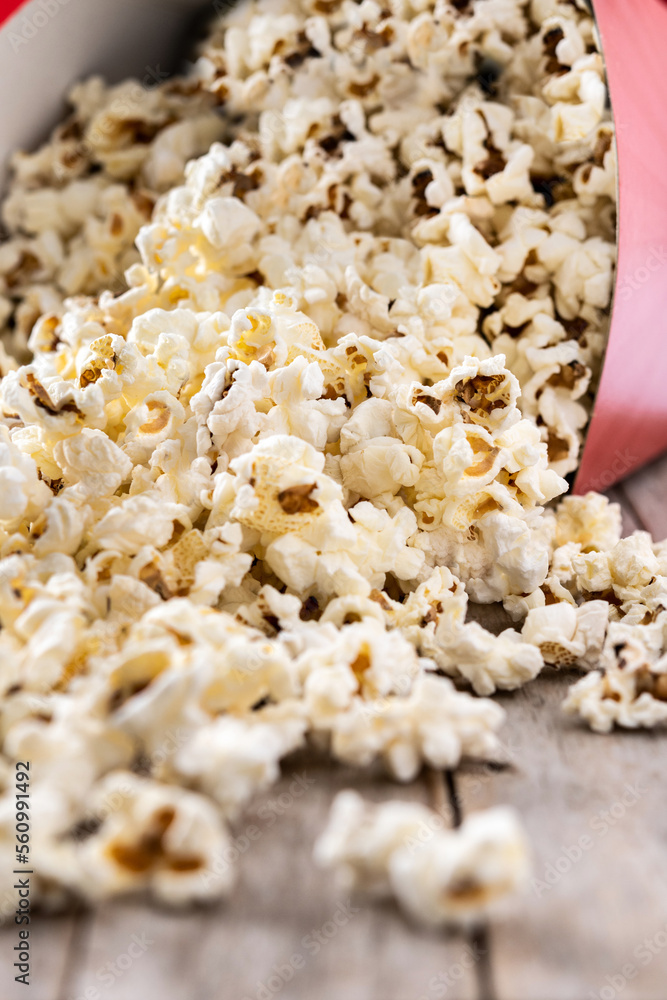 Salted popcorn scattered on wooden table. Close up Salted popcorn scattered on wooden table. Close up