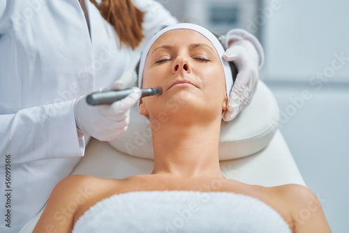Fotografija Woman in a beauty salon having needle mesotherapy treatment