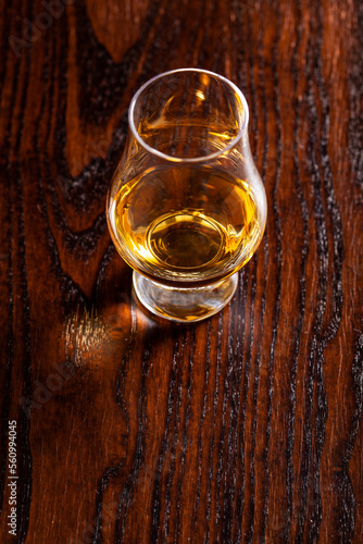 glass of whisky spirit brandy on dark brown background