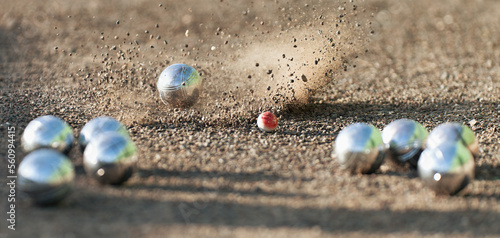 Photos Petanque ball boules bowls on a dust floor, photo in impact