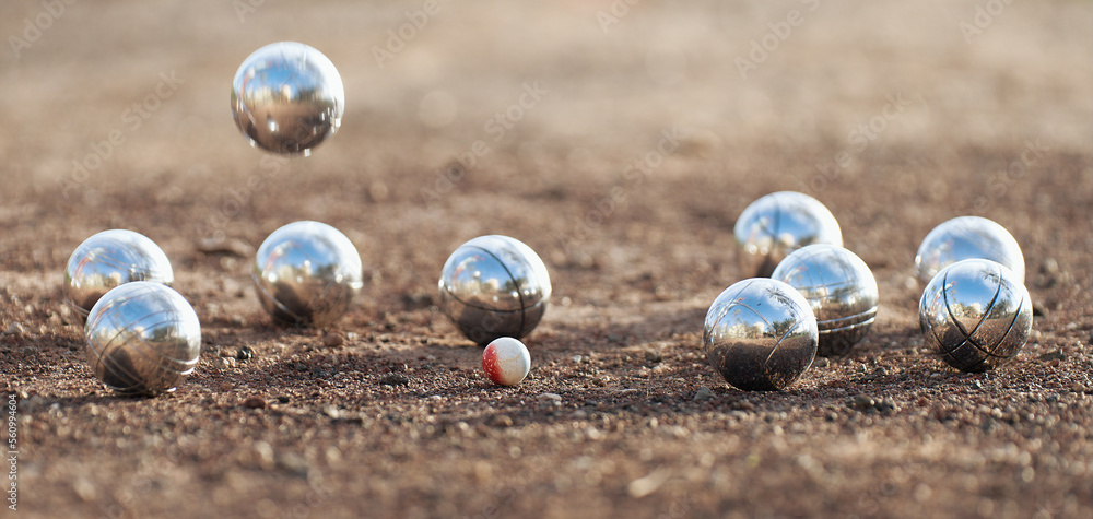 Petanque ball boules bowls on a dust floor, photo in impact. Game