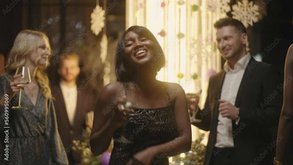 merry african american woman dancing in Christmas or New year party, lady with champagne glass merry african american woman dancing in Christmas or New year party, lady with champagne glass