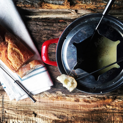 Overhead view of bread with cheese fondue on table