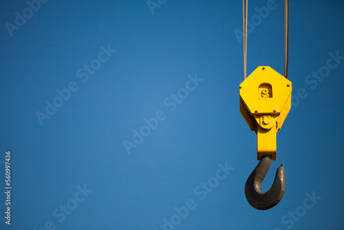 Crane hook against clear blue sky