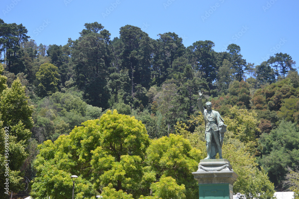 a statue on the side of a mountain with the blue sky