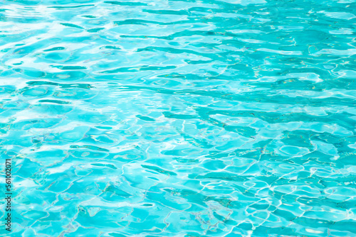 Ripple Water in swimming pool with blue tile floor background