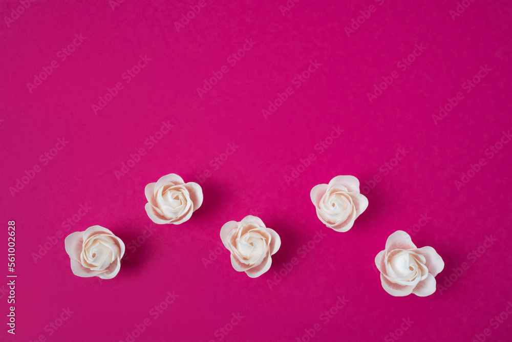 White roses on a pink background with space for text White roses on a pink background with space for text