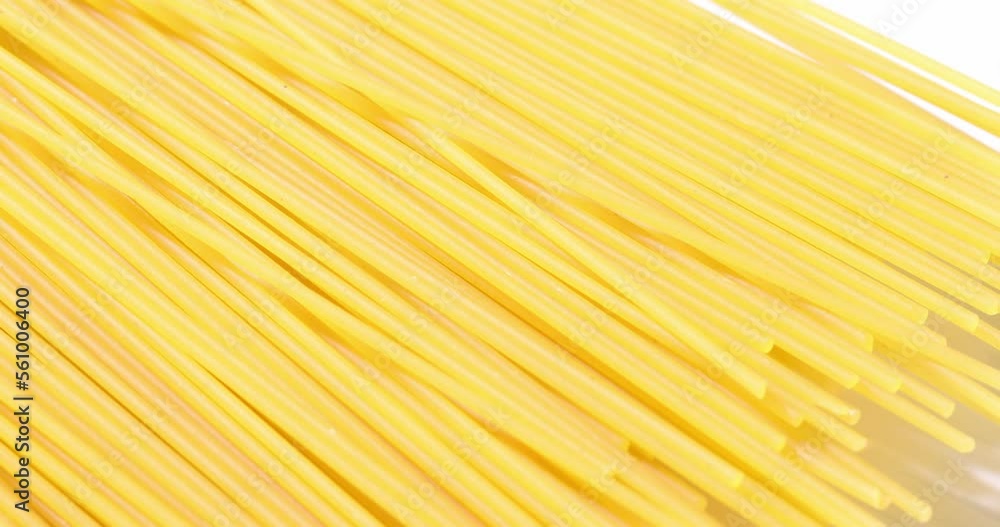 Uncooked pasta slow motion. Dry spaghetti macro shot. Macaroni in bright sunlight. Uncooked pasta slow motion. Dry spaghetti macro shot. Macaroni in bright sunlight.