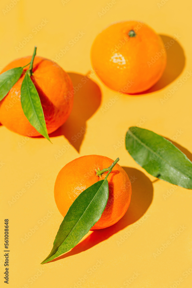 Creative compisition made of fresh orange tangerins on bright background. Healthy food concept. Summer refreshment theme. Creative compisition made of fresh orange tangerins on bright background. Healthy food concept. Summer refreshment theme.