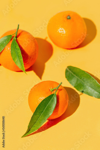 Creative compisition made of fresh orange tangerins on bright background. Healthy food concept. Summer refreshment theme.