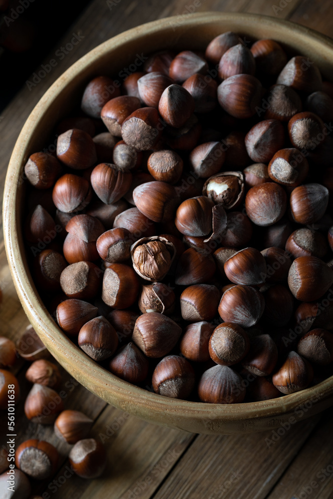 Shelled hazelnuts in bowl on a wooden table. Shelled hazelnuts in bowl on a wooden table.