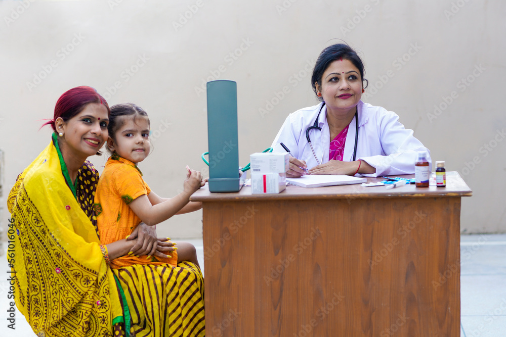 Indian woman doctor checking to little girl child at clinic. Stock ...