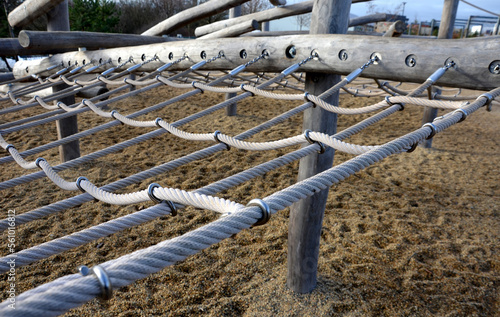 rope hemp net connected in a wooden frame by means of metal stainless steel connectors. it is an attraction for children on the playground. sand, screw, terrace, clambering, net, mesh , log, stacked