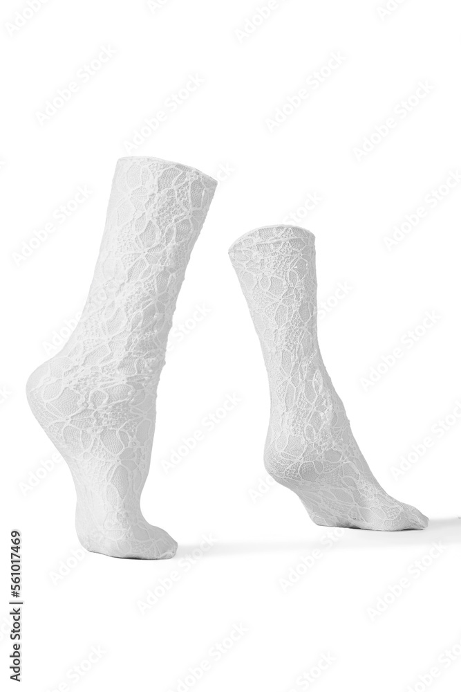 Detailed shot of white openwork translucent socks with a rubber band and abstract pattern. The socks are shaped as walking human legs. The semitransparent socks are isolated on a white background. Detailed shot of white openwork translucent socks with a rubber band and abstract pattern. The socks are shaped as walking human legs. The semitransparent socks are isolated on a white background.