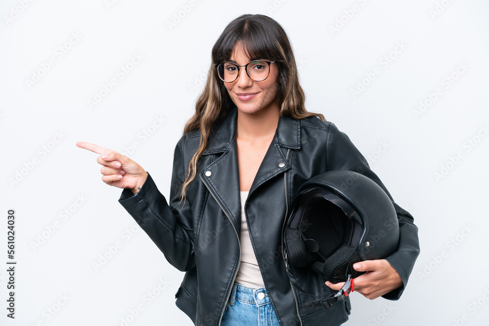 Young caucasian woman with a motorcycle helmet isolated on white background pointing finger to the side Young caucasian woman with a motorcycle helmet isolated on white background pointing finger to the side
