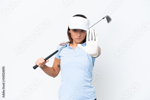 Young caucasian woman playing golf isolated on white background making stop gesture