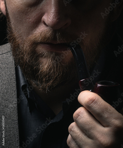 stylish man in retro outfit suit hat smoking wooden pipe sherlock holmes look cosplay england gentleman fashionable confident gangster Guy Ritchie Charlie Hunnam style