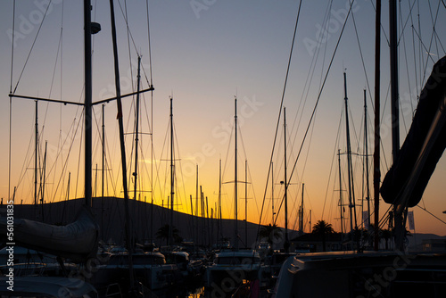 Fototapeta Naklejka Na Ścianę i Meble -  Close-up of yacht masts against the sunset sky. Marine theme