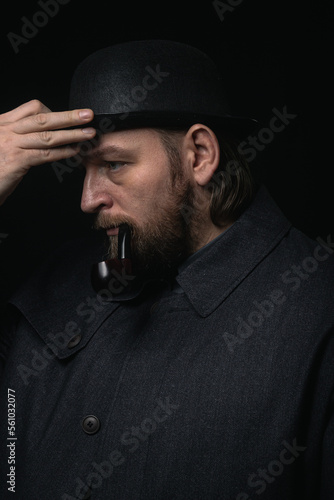 stylish man in retro outfit suit hat smoking wooden pipe sherlock holmes look cosplay england gentleman fashionable confident gangster Guy Ritchie Charlie Hunnam style photo