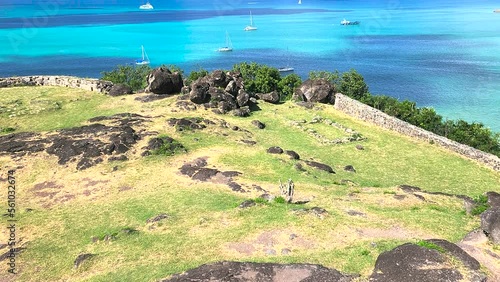 Tilt up-From the point of the ruins of old Fort Lewis to the bay at Marigot on the French half of Saint Martin island and beyond to clouds on the ocean horizon photo