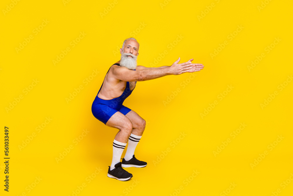 Full length photo of old senior coach sitting preparation flexibility warmup training professional bodybuilder advert sport app isolated on yellow color background