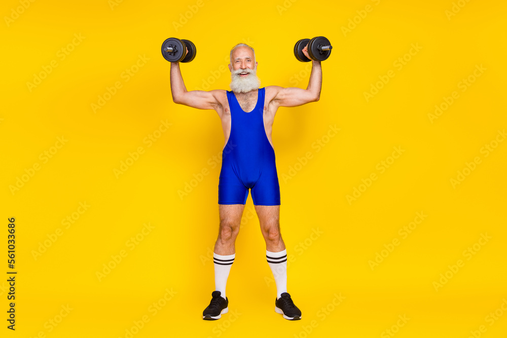 Full length photo of senior sporty professional trainer muscular arm raise heavy barbell wear suit isolated on yellow color background - obrazy, fototapety, plakaty 