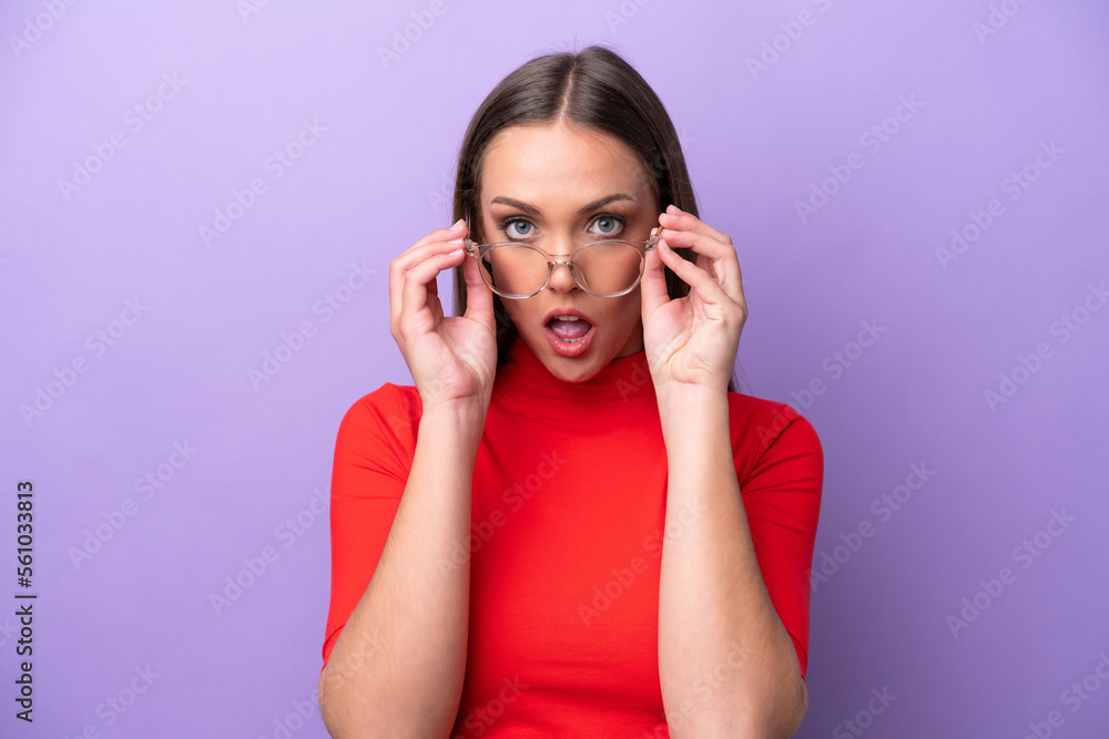 Young caucasian woman isolated on purple background With glasses and surprised expression Young caucasian woman isolated on purple background With glasses and surprised expression